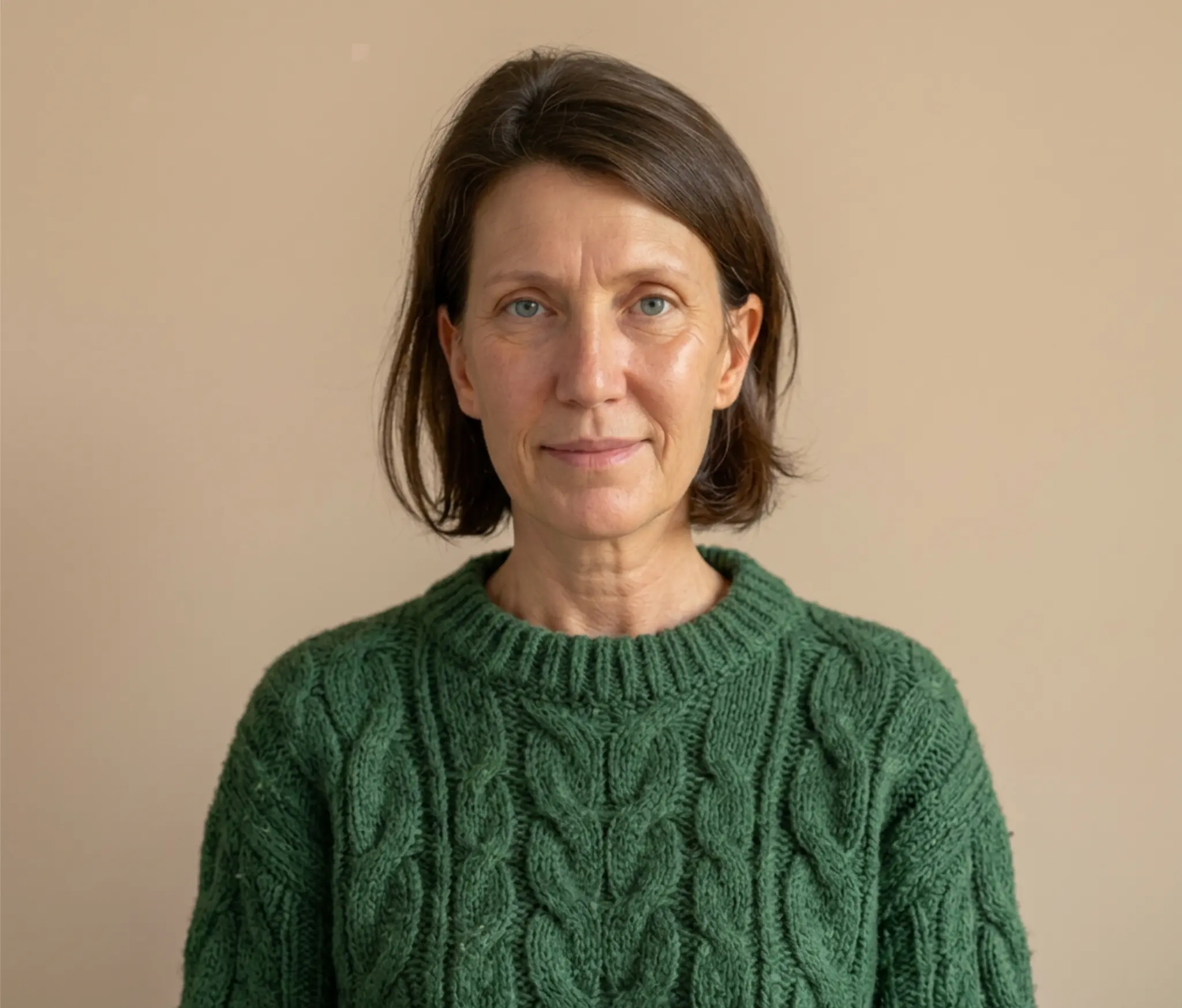 Portrait of a counsellor Richanda wearing a green sweater.